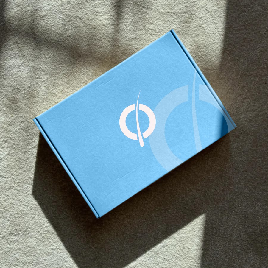 A plain cardboard box on a sunny floor